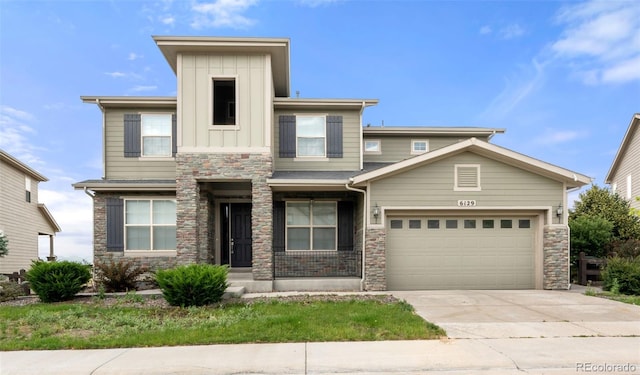 6129 E 143rd Ave, Thornton, CO 80602 - view of front facade with stone siding, driveway, a garage, and board and batten siding