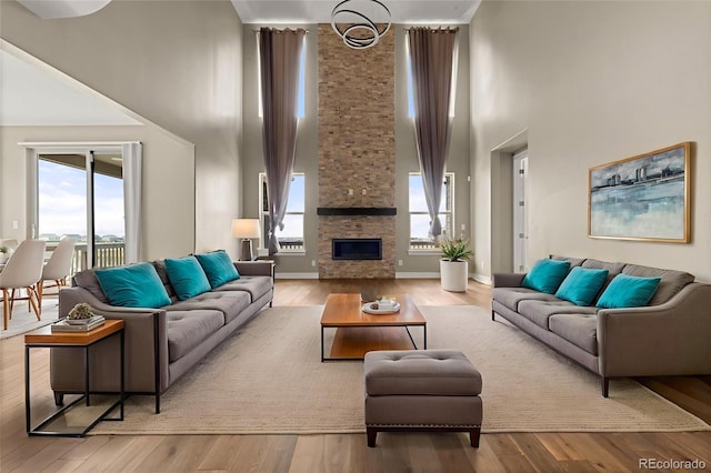 6129 E 143rd Ave, Thornton, CO 80602 - living area featuring a high ceiling, a fireplace, and wood finished floors