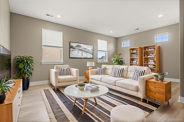 6129 E 143rd Ave, Thornton, CO 80602 - living room featuring light wood-style flooring and recessed lighting