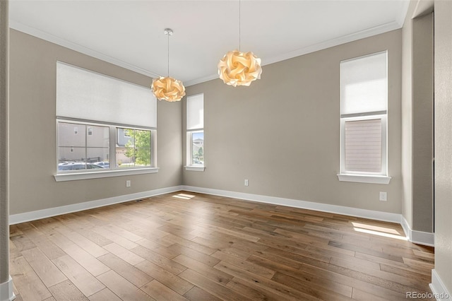 6129 E 143rd Ave, Thornton, CO 80602 - spare room featuring crown molding, a chandelier, and wood-type flooring