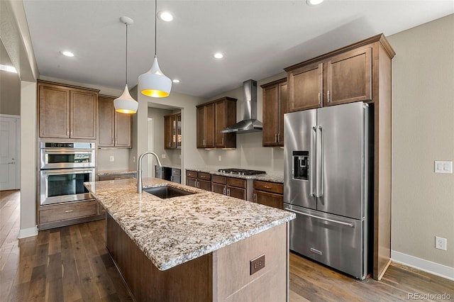 6129 E 143rd Ave, Thornton, CO 80602 - kitchen with stainless steel appliances, wall chimney range hood, dark wood-style floors, light stone counters, and a kitchen island with sink