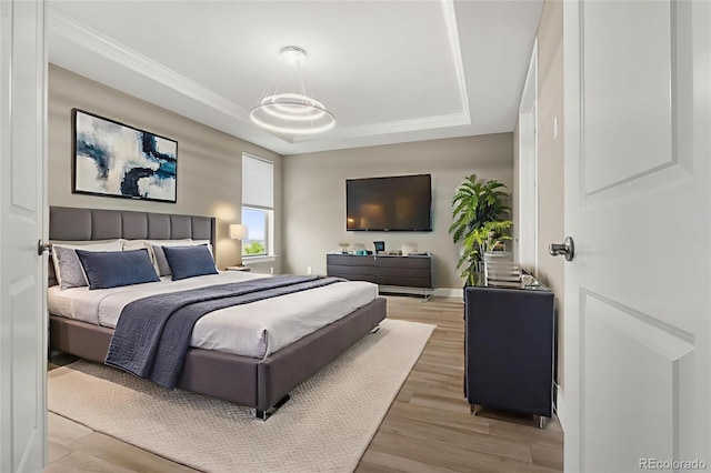 6129 E 143rd Ave, Thornton, CO 80602 - bedroom featuring a raised ceiling and light wood finished floors