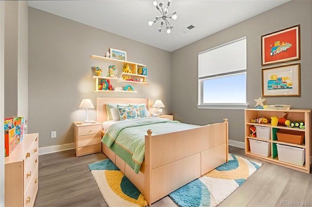 6129 E 143rd Ave, Thornton, CO 80602 - bedroom with wood finished floors and a chandelier