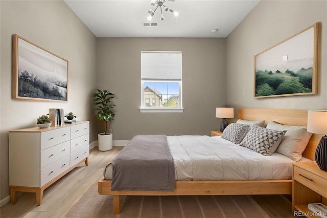 6129 E 143rd Ave, Thornton, CO 80602 - bedroom featuring light wood-style floors and a chandelier