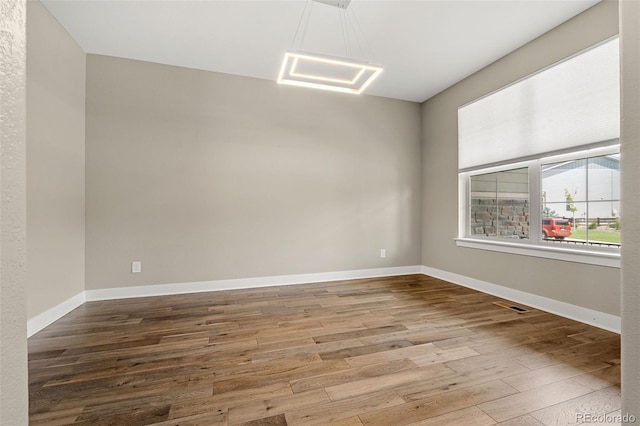 6129 E 143rd Ave, Thornton, CO 80602 - spare room featuring wood finished floors and baseboards