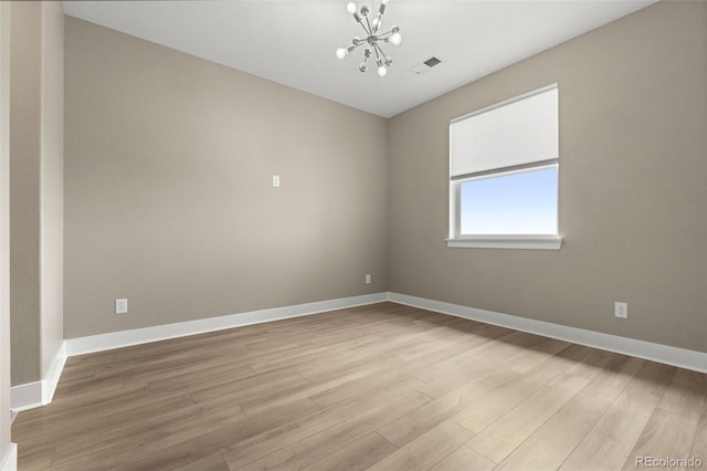 6129 E 143rd Ave, Thornton, CO 80602 - empty room featuring a chandelier and light wood-style flooring
