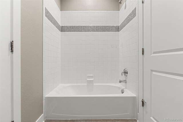6129 E 143rd Ave, Thornton, CO 80602 - bathroom with washtub / shower combination and a textured wall