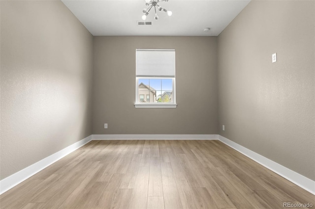 6129 E 143rd Ave, Thornton, CO 80602 - empty room featuring a chandelier and light wood-style flooring