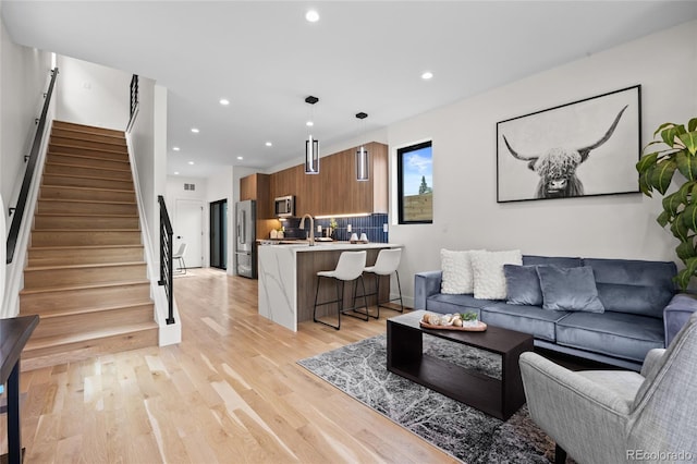 1747 Lowell Blvd, Denver, CO 80204 - living area featuring stairway, light wood-type flooring, and recessed lighting