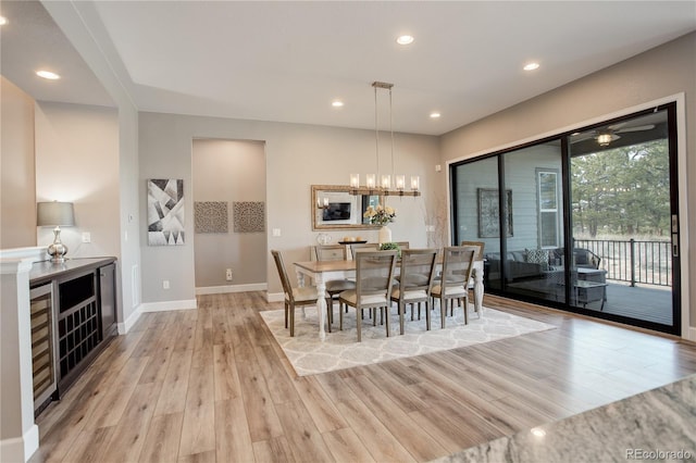 dining space featuring light hardwood / wood-style floors and an inviting chandelier