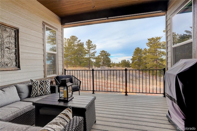 wooden terrace featuring outdoor lounge area and area for grilling