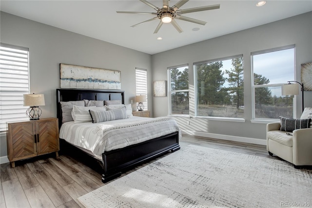 bedroom featuring ceiling fan and light hardwood / wood-style flooring