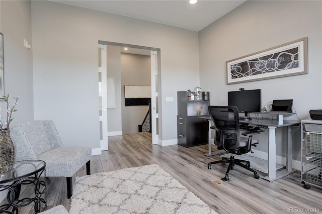 home office with light hardwood / wood-style floors