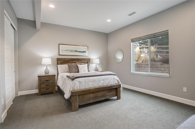 carpeted bedroom with beam ceiling