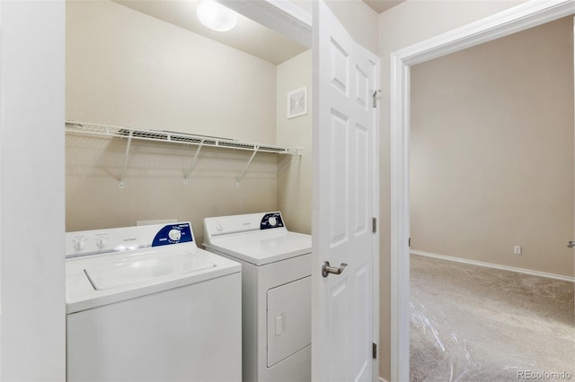 laundry room with washer and clothes dryer and carpet floors