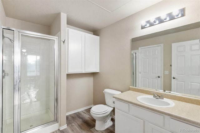 bathroom with a shower with shower door, toilet, wood-type flooring, and vanity