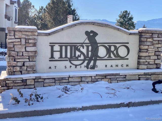 community / neighborhood sign with a mountain view