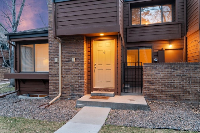 property entrance featuring brick siding