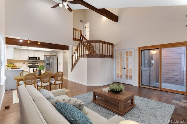 living room featuring visible vents, beamed ceiling, french doors, baseboards, and ceiling fan