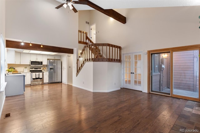 unfurnished living room featuring a ceiling fan, wood finished floors, visible vents, baseboards, and french doors