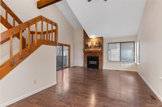 unfurnished living room featuring wood finished floors, visible vents, baseboards, a fireplace, and stairs