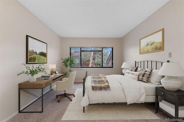 bedroom with baseboards and carpet