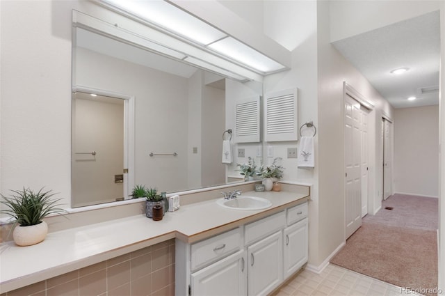 bathroom with vanity and baseboards