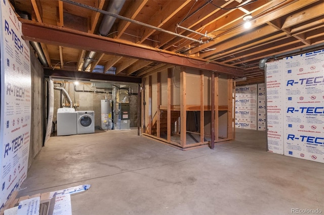 unfinished basement with water heater and washer and clothes dryer