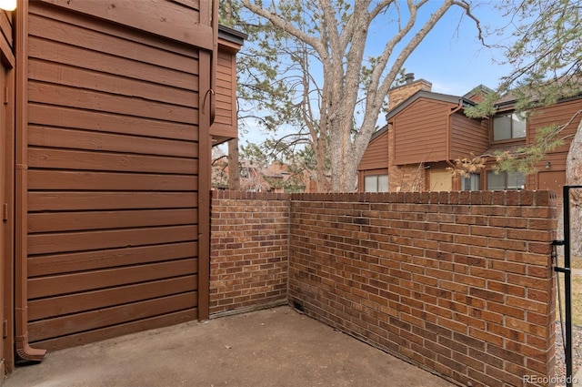 view of patio featuring fence