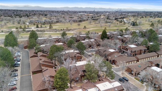 drone / aerial view with view of golf course, a mountain view, and a residential view