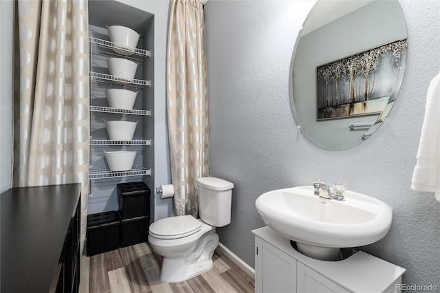 4797 Flower St, Wheat Ridge, CO 80033 - bathroom featuring wood finished floors, toilet, baseboards, vanity, and a textured wall