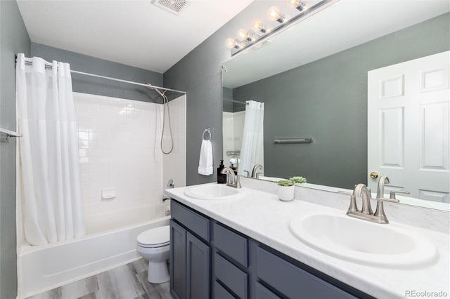 4797 Flower St, Wheat Ridge, CO 80033 - full bath with shower / tub combo with curtain, double vanity, toilet, and wood finished floors