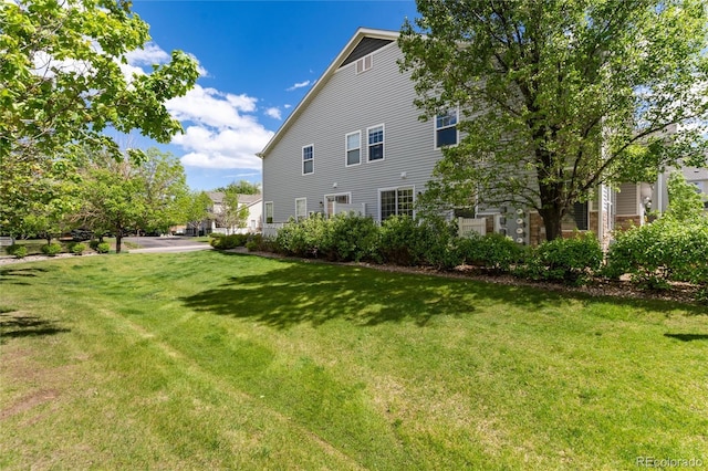 4797 Flower St, Wheat Ridge, CO 80033 - back of house with a yard