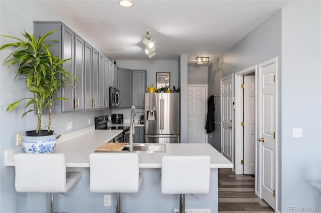 4797 Flower St, Wheat Ridge, CO 80033 - kitchen with appliances with stainless steel finishes, gray cabinets, a peninsula, and light countertops