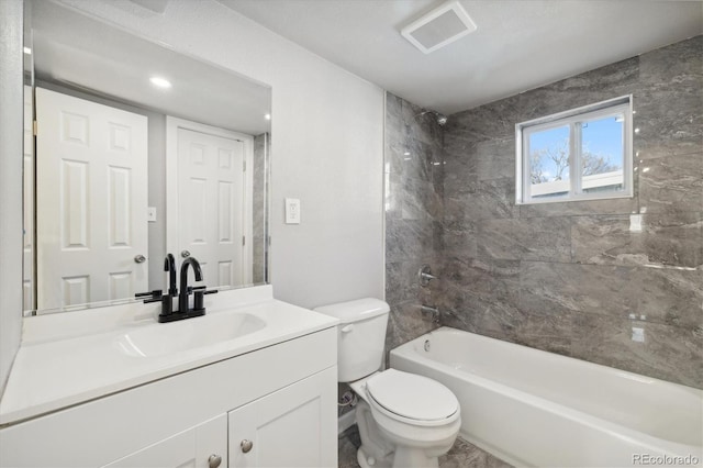 full bathroom featuring vanity, tiled shower / bath combo, and toilet