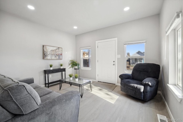 living room with light hardwood / wood-style flooring