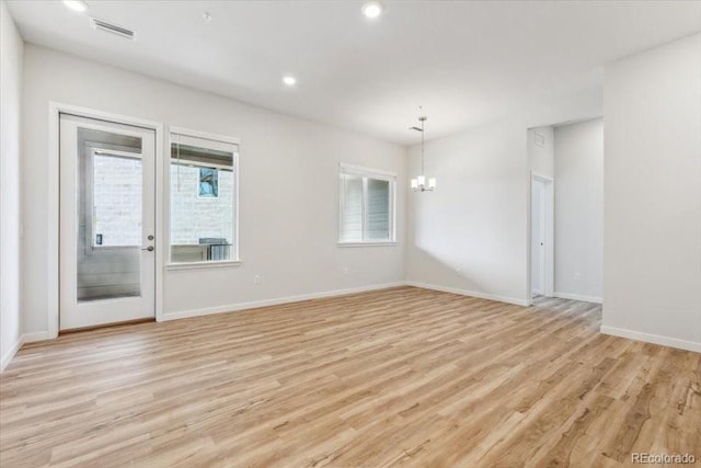 485 Interlocken Blvd Unit 106, Broomfield, CO 80021 - spare room with a chandelier, light wood finished floors, recessed lighting, and baseboards