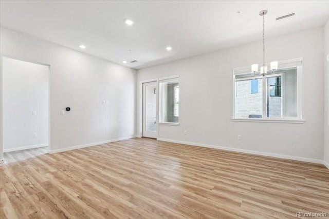 485 Interlocken Blvd Unit 106, Broomfield, CO 80021 - spare room with a chandelier, light wood finished floors, baseboards, and recessed lighting