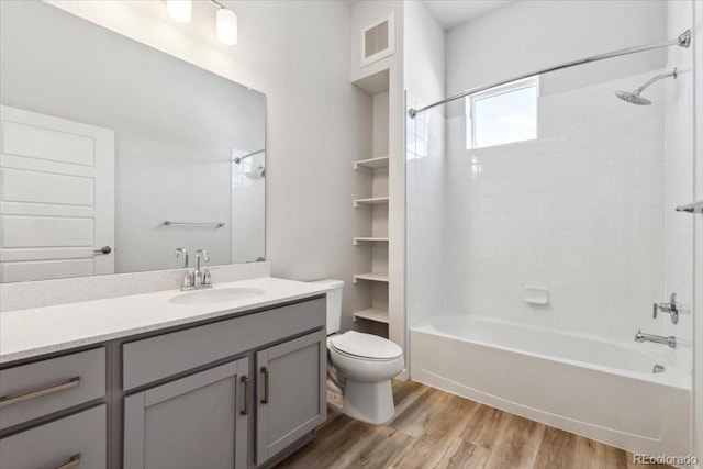 485 Interlocken Blvd Unit 106, Broomfield, CO 80021 - full bath with wood finished floors, toilet, vanity, and bathing tub / shower combination