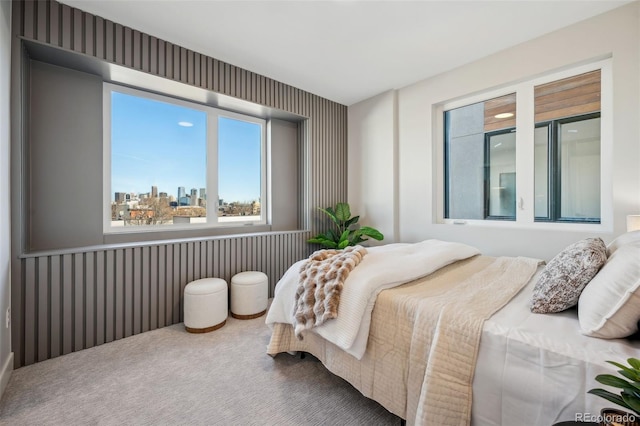 bedroom featuring a city view, carpet flooring, and wallpapered walls