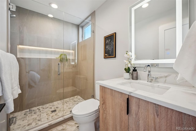 bathroom with toilet, vanity, recessed lighting, and a stall shower