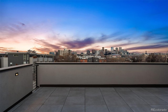 balcony at dusk with a view of city