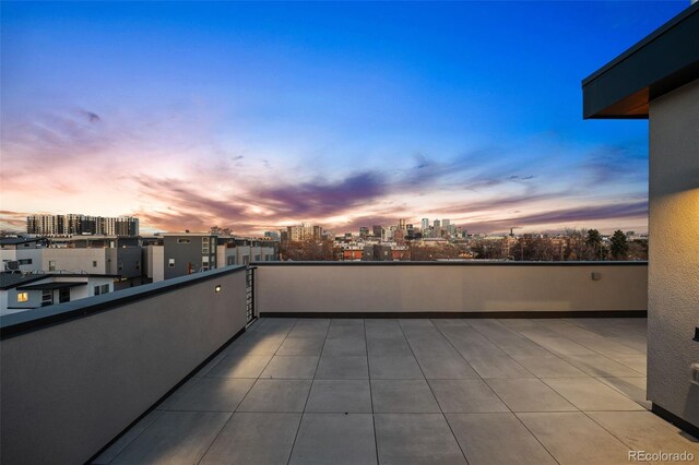 view of patio / terrace with a balcony and a city view