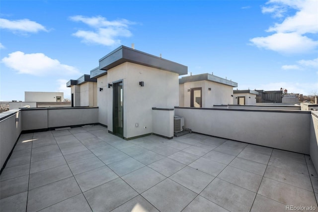 view of patio with central air condition unit and a balcony