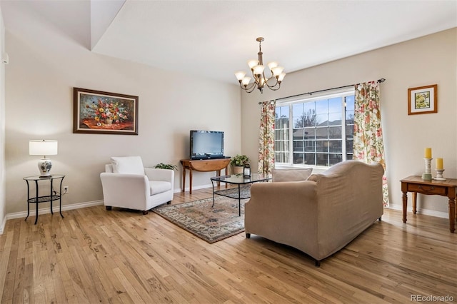 living room with light wood-type flooring, a chandelier, and baseboards