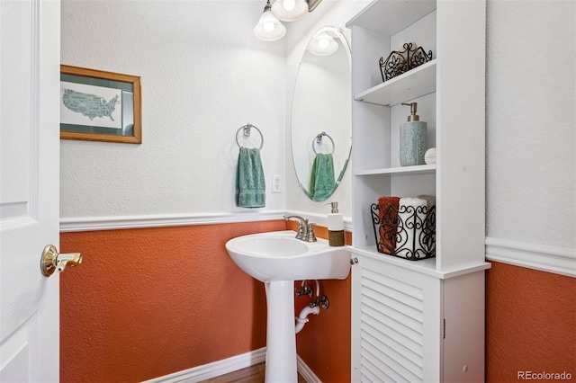 bathroom featuring a textured wall