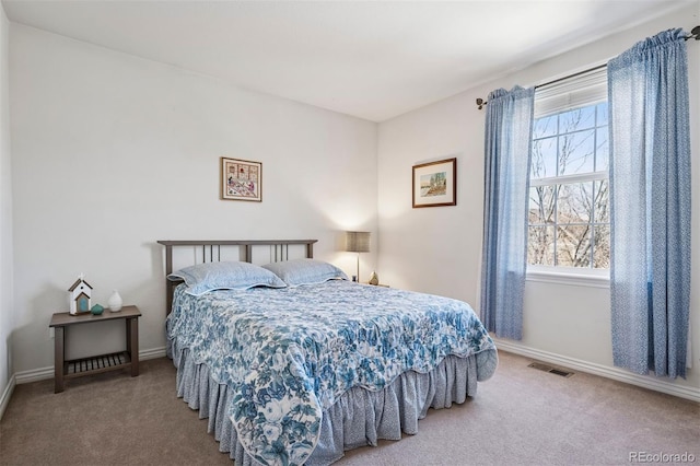 carpeted bedroom featuring baseboards