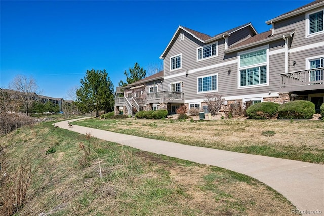 view of property's community featuring a wooden deck and a lawn