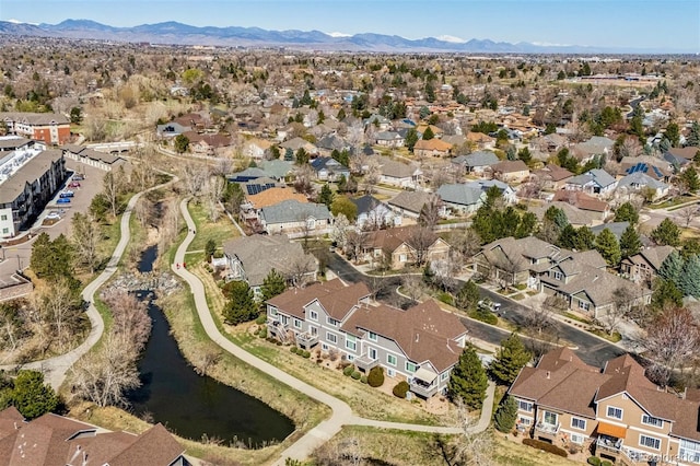aerial overview of property's location featuring a water and mountain view and nearby suburban area