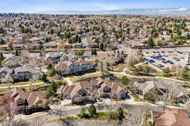 aerial view of property and surrounding area featuring nearby suburban area and a mountain backdrop